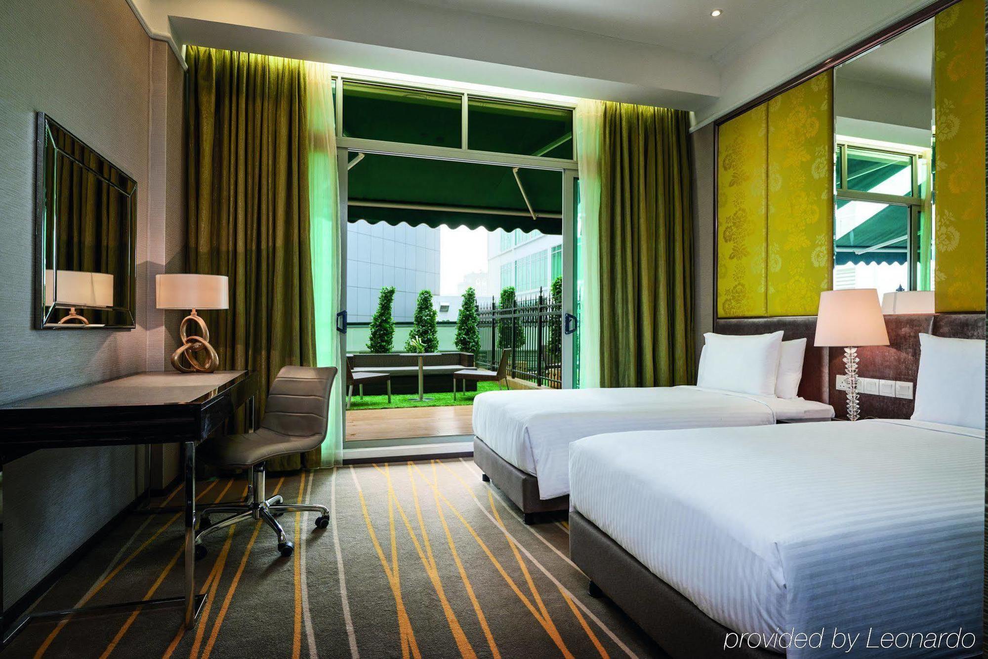 Hotel Dorsett Putrajaya Exteriér fotografie The photo shows a modern hotel room featuring two twin beds, each with white bedding. The room has a stylish decor with a large window that allows natural light to enter. Green curtains frame the window, which opens to a balcony that overlooks an out